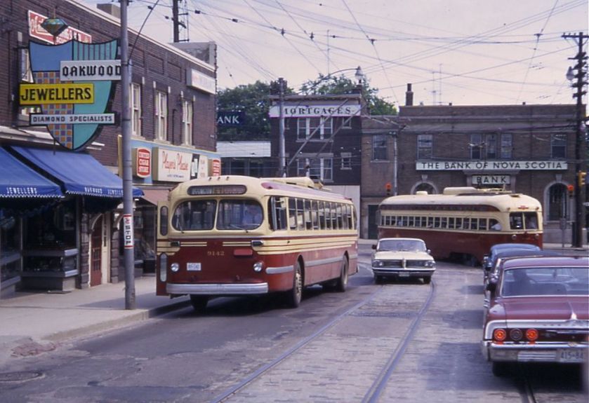 Toronto_CCF-Brill_trolleybus_passing_PCC_streetcar_on_Oakwood_St,_1968