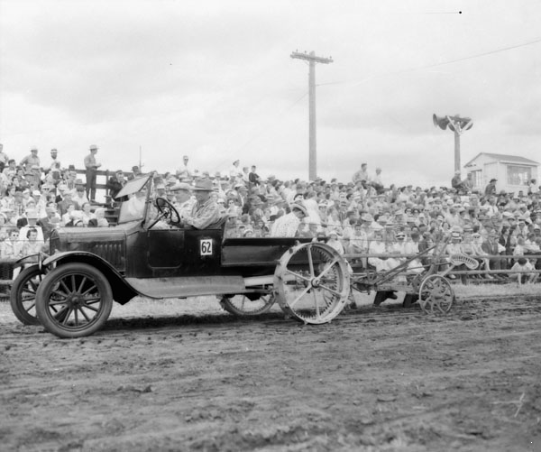 A Model T homemade tractor pulling a plow