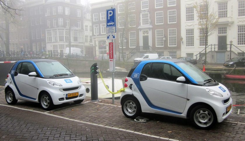 Two Smart Electric Vehicle cars deployed in the Car2Go carsharing program charging at the Herengracht in Amsterdam