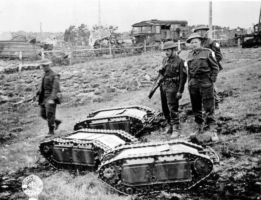 British soldiers with captured German Goliath tracked mines.