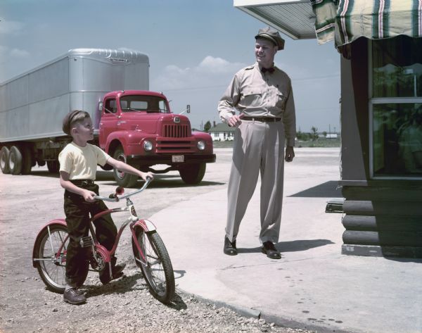 1950 International Truck Driver Talking with a Boy on a Bike