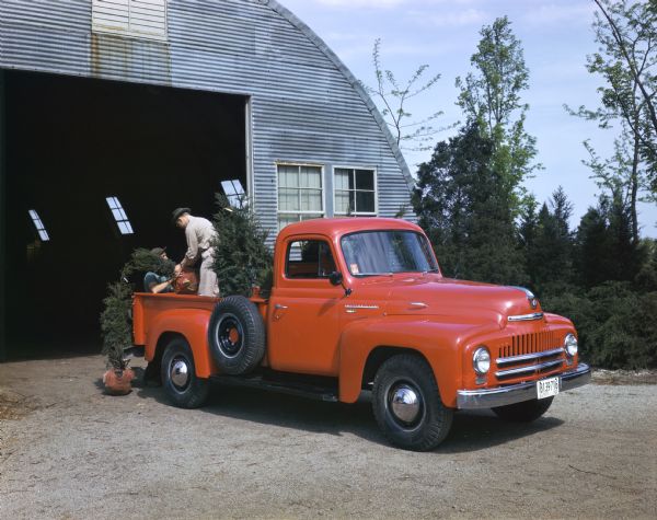 1950 Loading trees into an International L-120 truck
