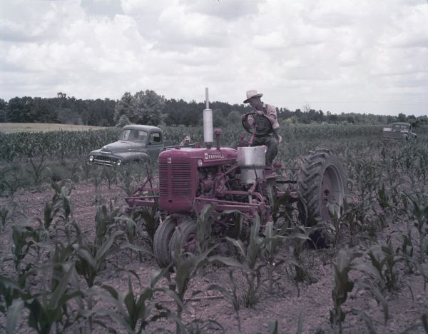 1952 Man Using Super C Tractor with Cultivator