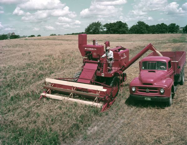 1954 McCormick No. 141 harvester-thresher (combine) and an International truck