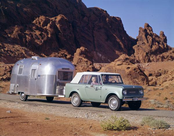 1965 International Scout pickup pulling an Airstream camper in the Nevada hills