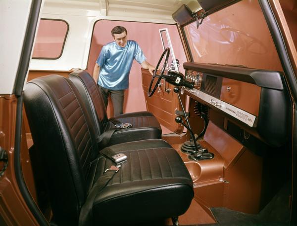 1968 Man Inspects Interior of International Scout 800A Pickup