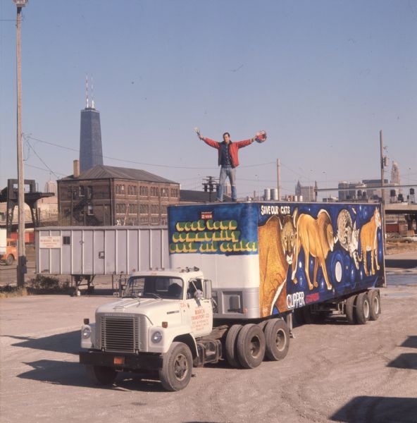 1975 Man Standing Atop Truck Trailer with Big Cat Mural