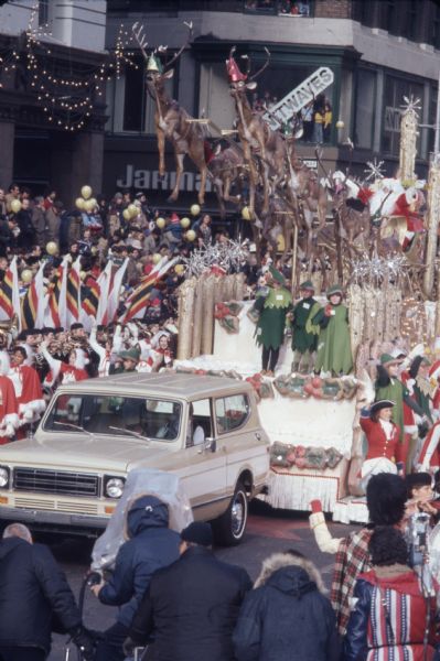 1976 white International Harvester Scout 4x4 is pulling a float with a Santa Claus theme