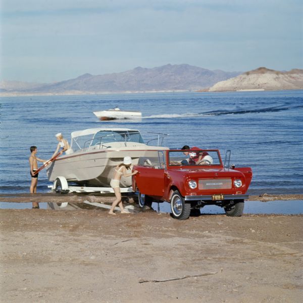 Young Couples Load Boat onto Trailer at Lake from International Scout Pickup